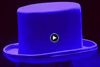 A tall tower in front of a large brick building